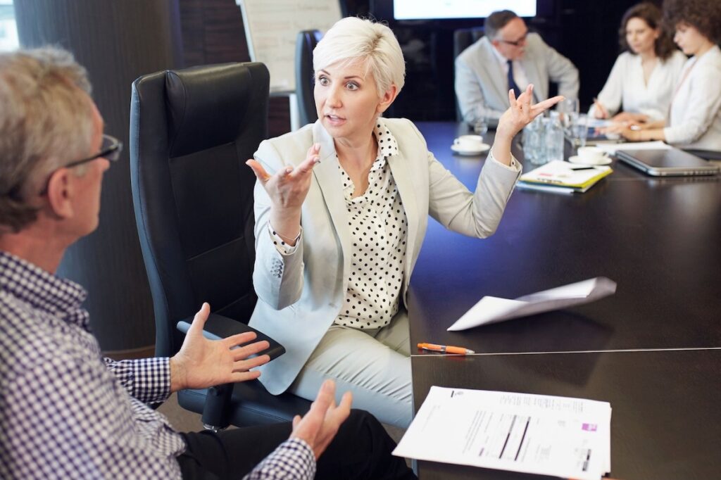 Business people at conference table in serious discussion