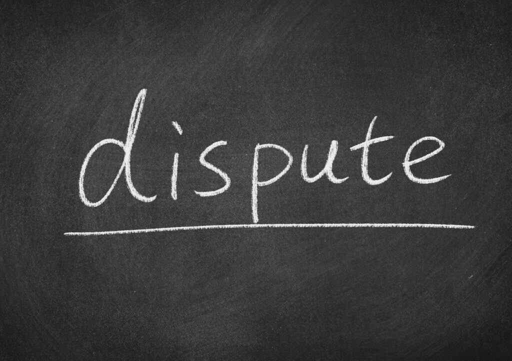 The word dispute written on a chalk board. 