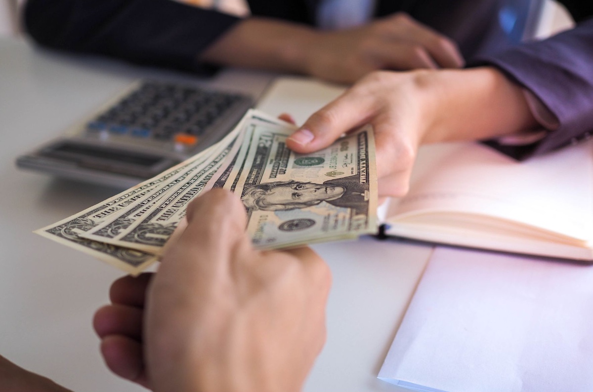 Money changing hands from a loan or investment