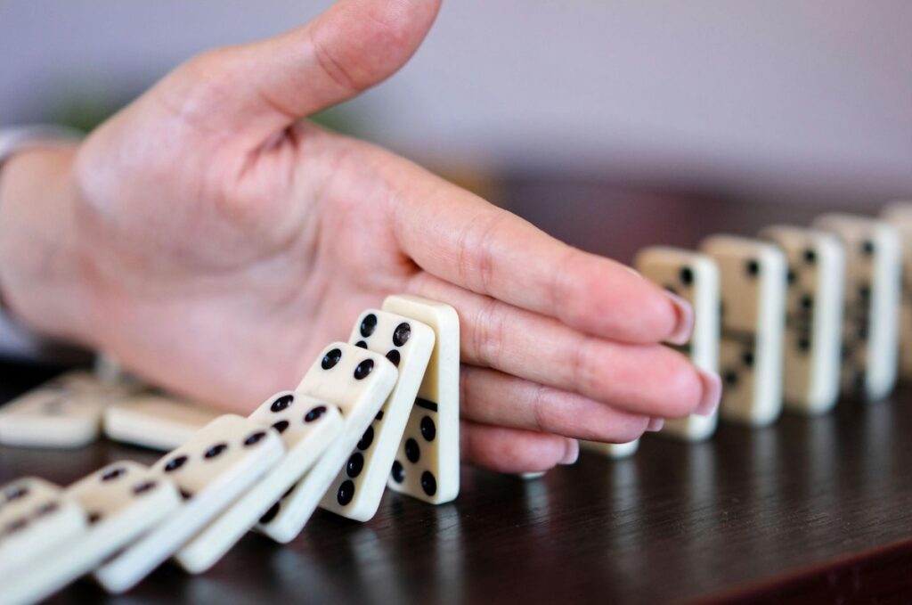 Stopping falling dominoes