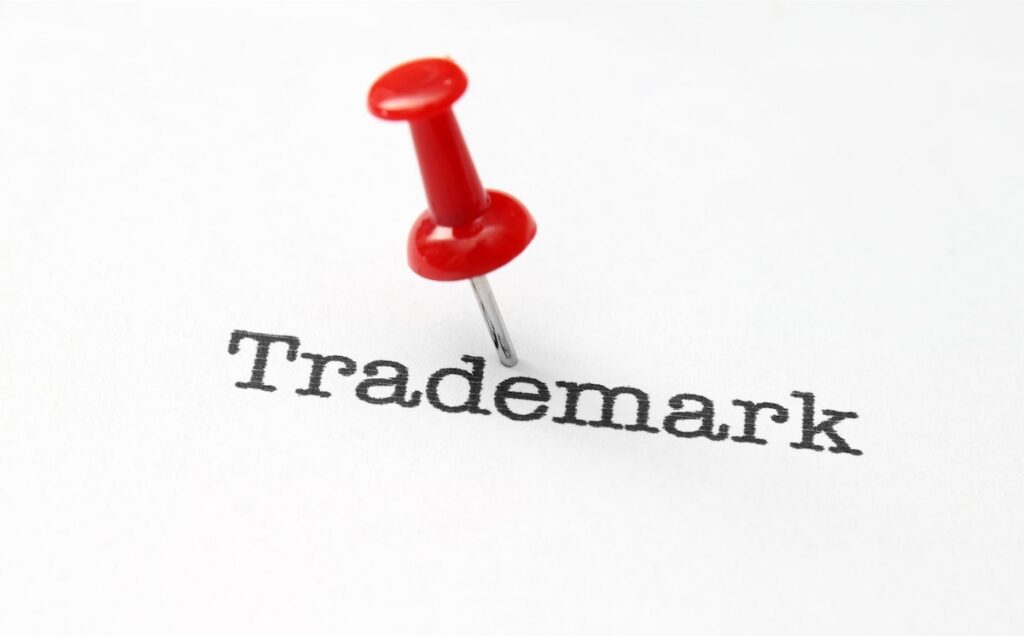 Trademark with a red thumbtack
