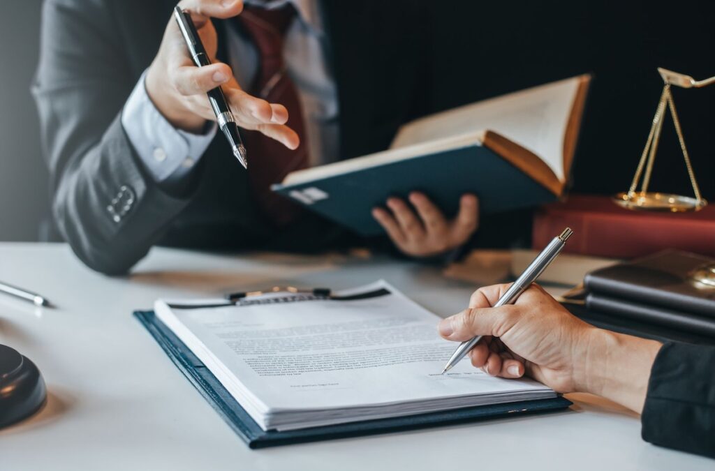 Legal brief writing with a colleague with law book