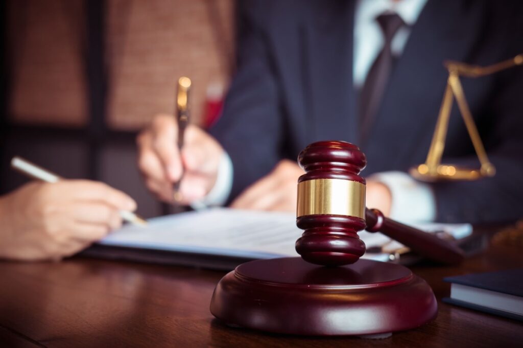 Two lawyers working together on a document