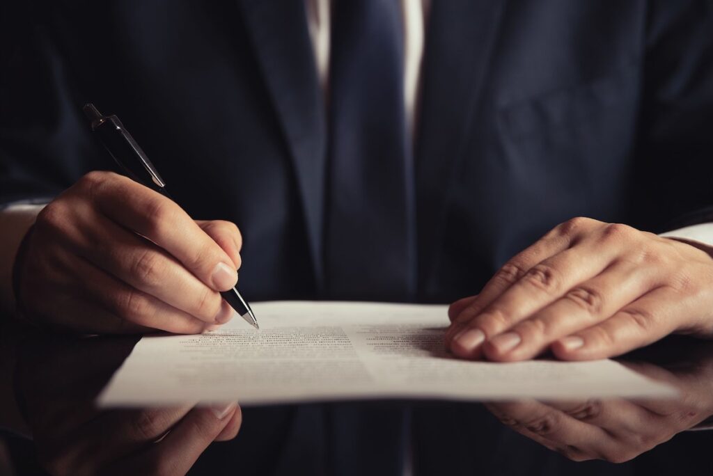 Man reviewing documents with a pen