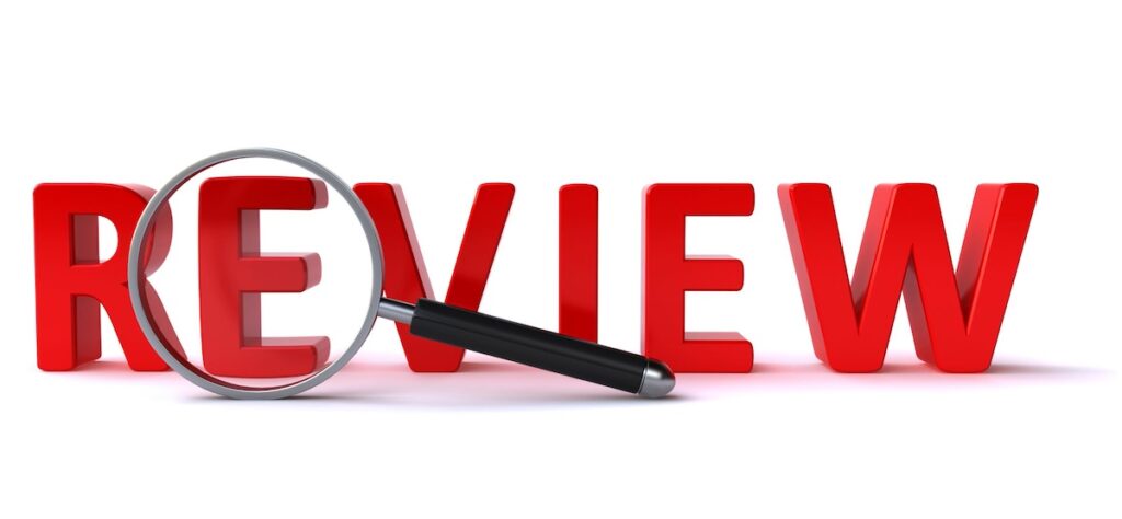 The word review with a magnifying glass